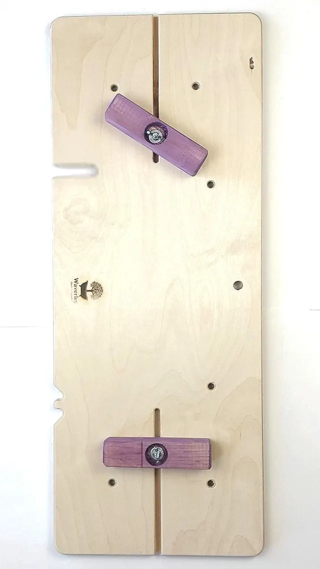 The underside of a natural birch board with both plum-stained slide-adjustable footers bolted along their channels, and the Waverley mark burned into the wood between them.