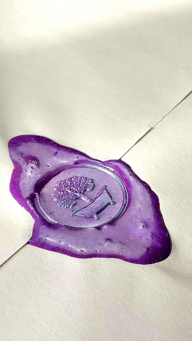 A hand-poured purple wax seal closing a cream envelope, stamped with the Waverley tree-and-tub crest.